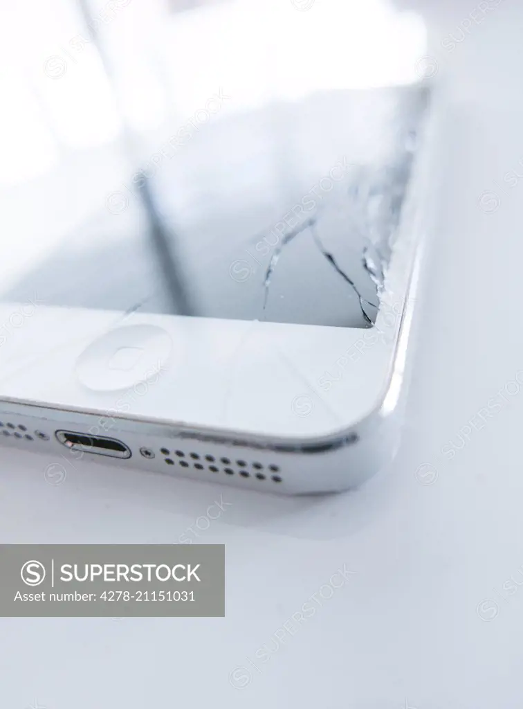 Close up of White Smart Phone with Cracked Screen