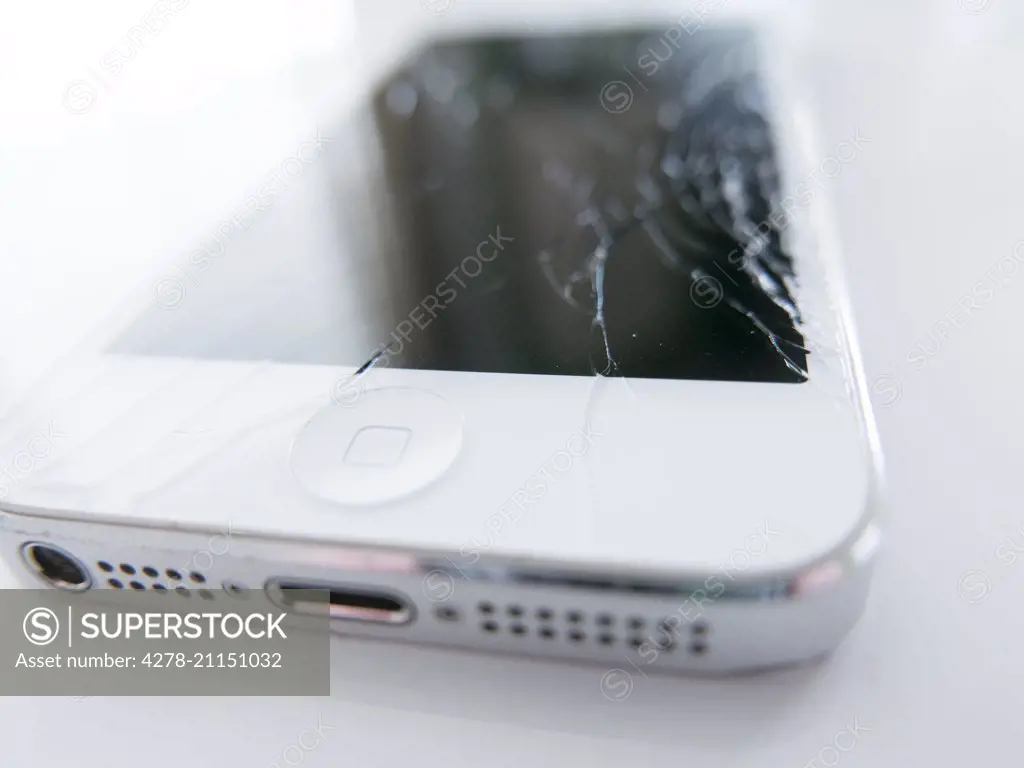 Close up of White Smart Phone with Cracked Screen
