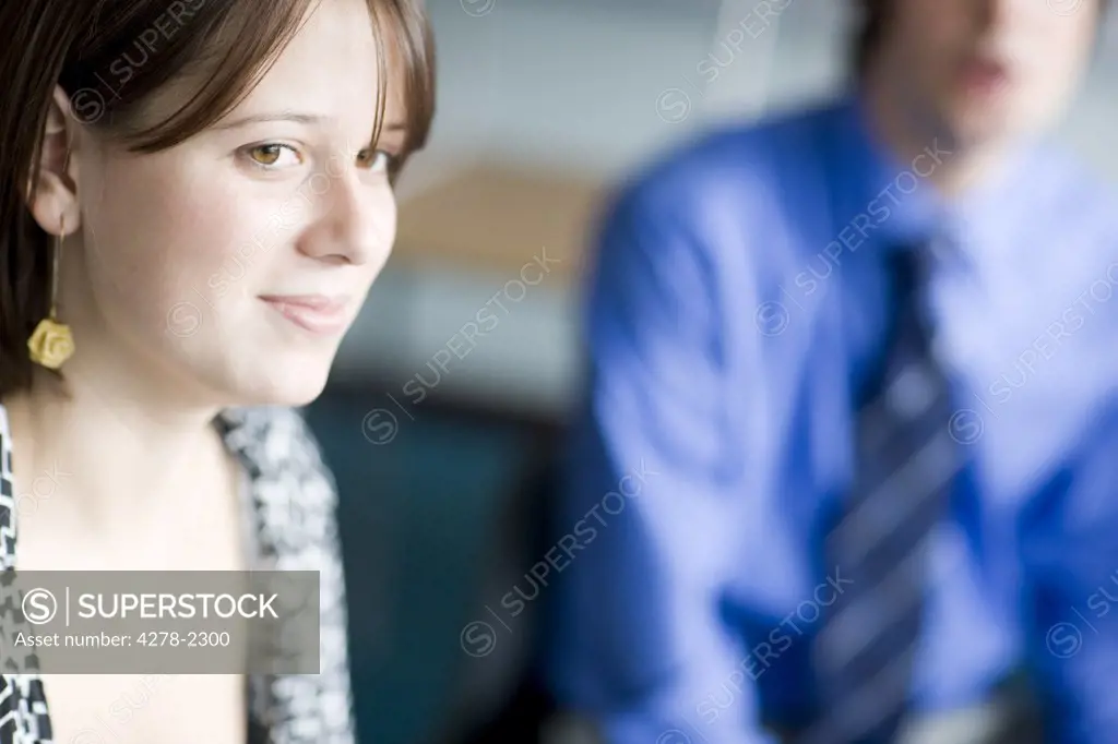 Portrait of young businesswoman with colleague