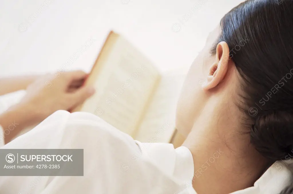 Back view of woman reading book