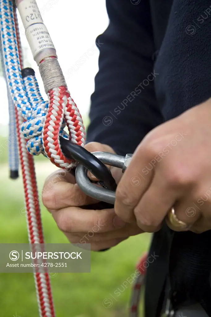 Close up of climber hands holding carabina key ring