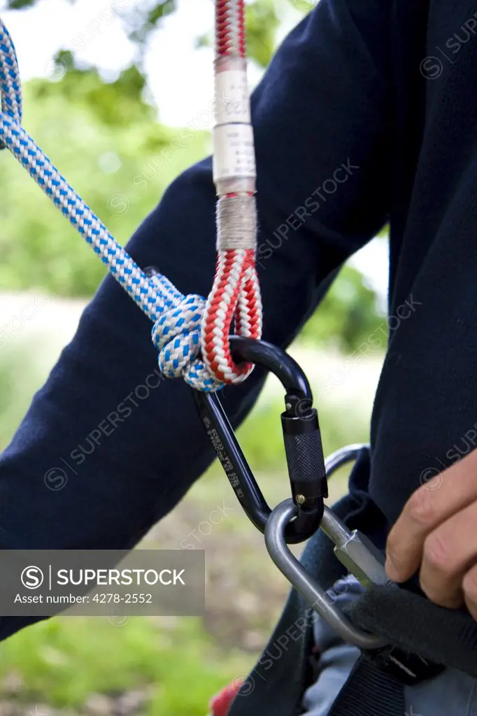 Close up of climber arm and climbing gear