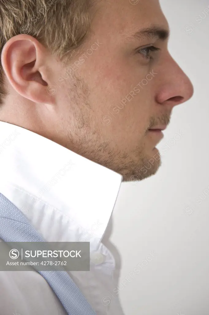 Profile of young man with shirt collar up