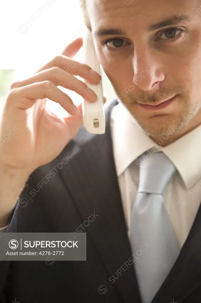 Close up of young businessman talking on the phone