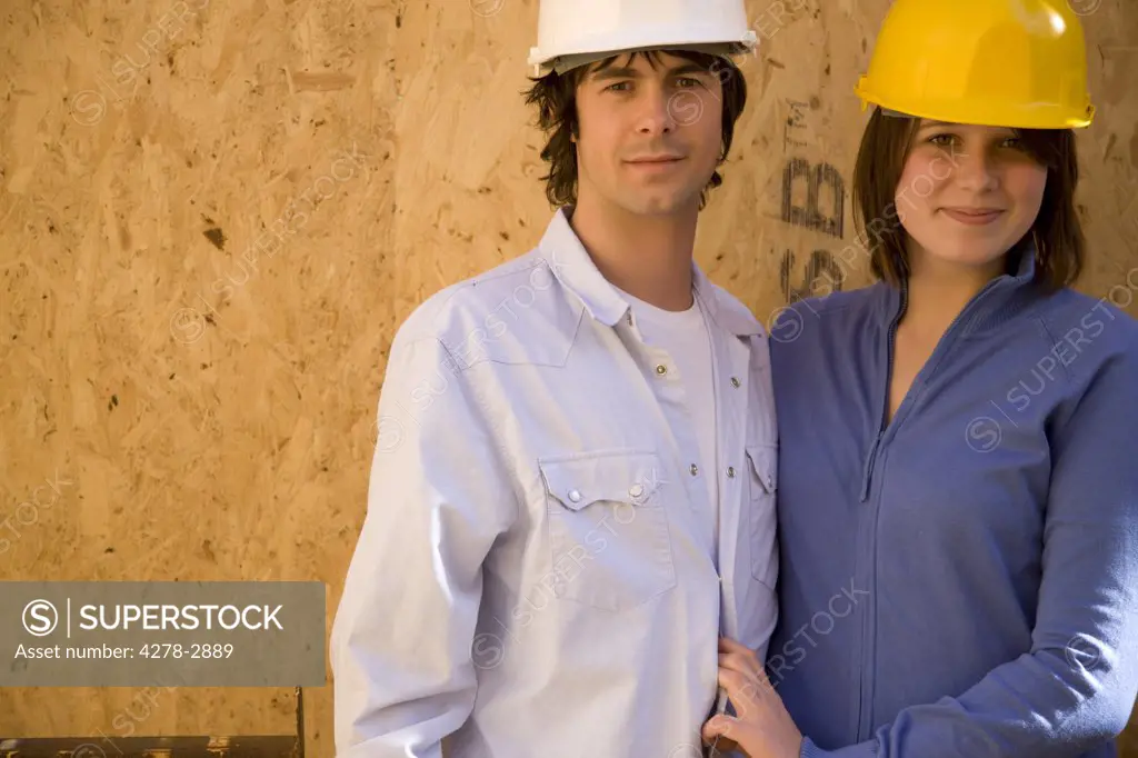Portrait of a couple at construction site smiling