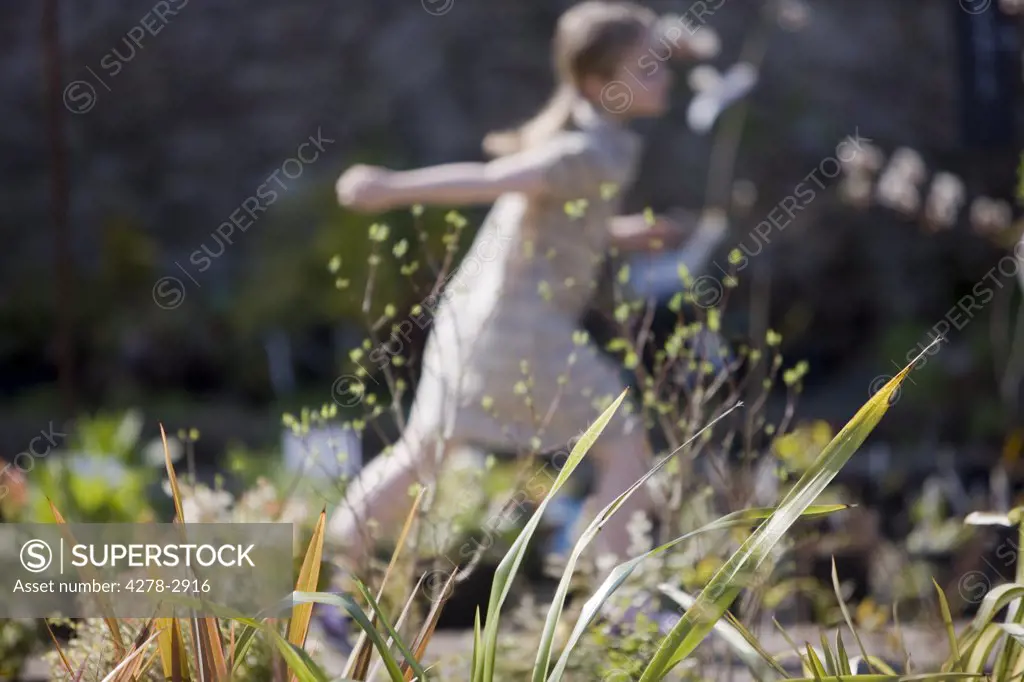 Young girl running around in a nursery