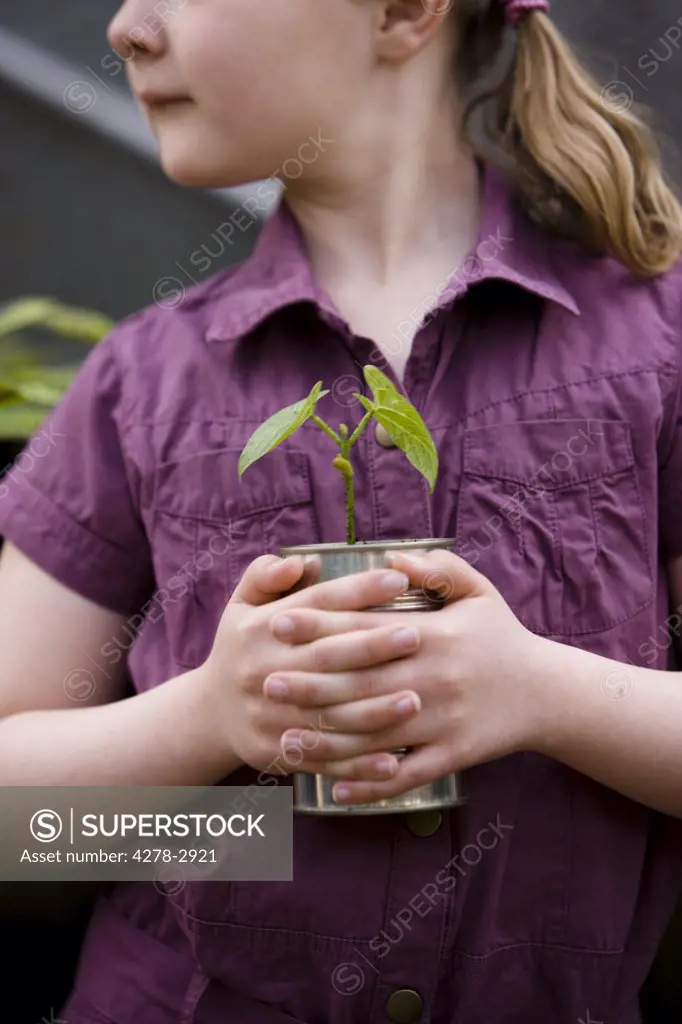 Close up of girl holding a plant