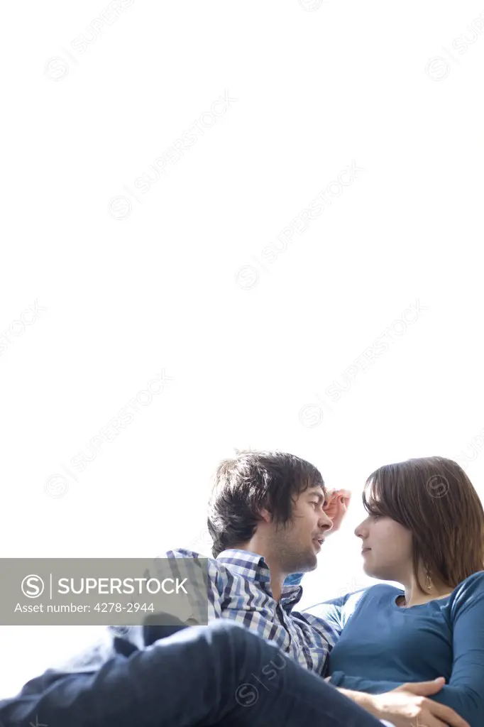 Portrait of young couple talking and looking at each other