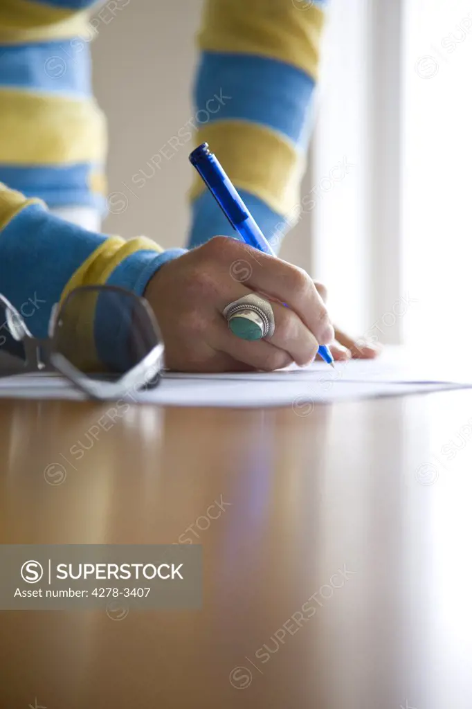 Close up of a woman hands signing documents