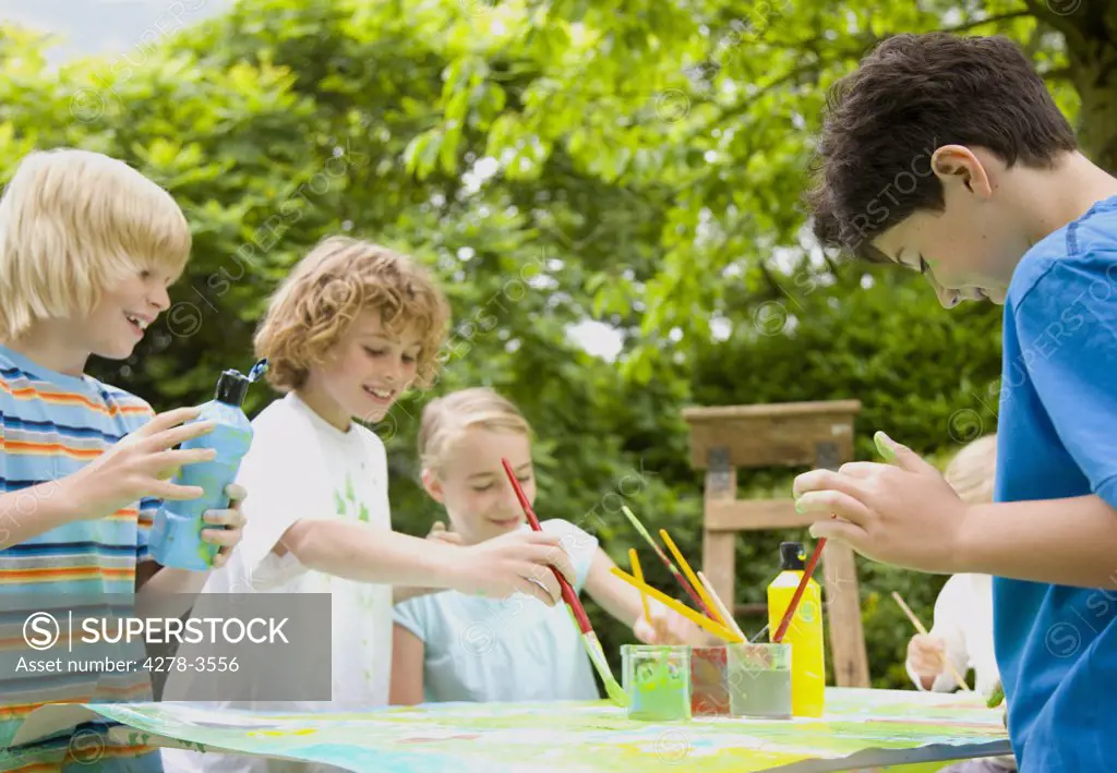 Children painting and smiling