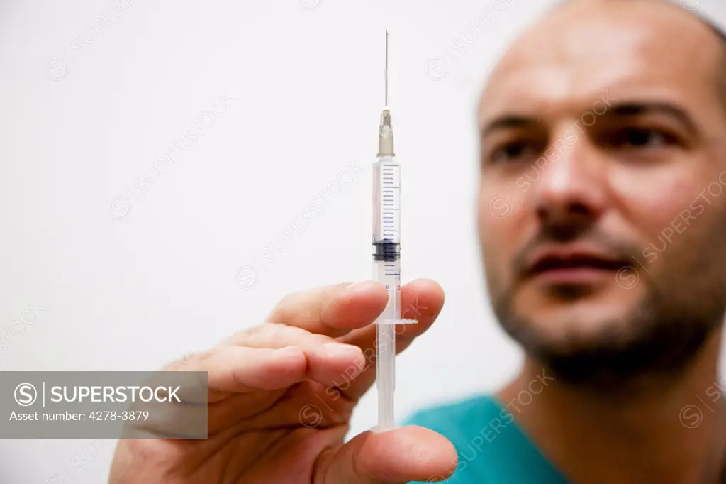 Healthcare professional holding a syringe