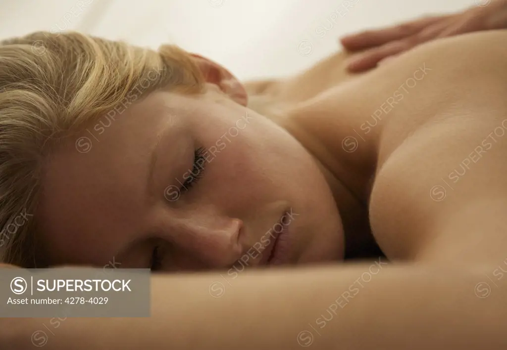 Close up of a young woman receiving a back massage