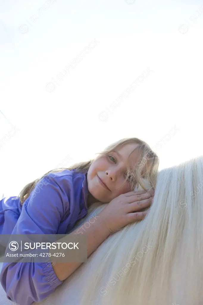 Young Girl Hugging Horse