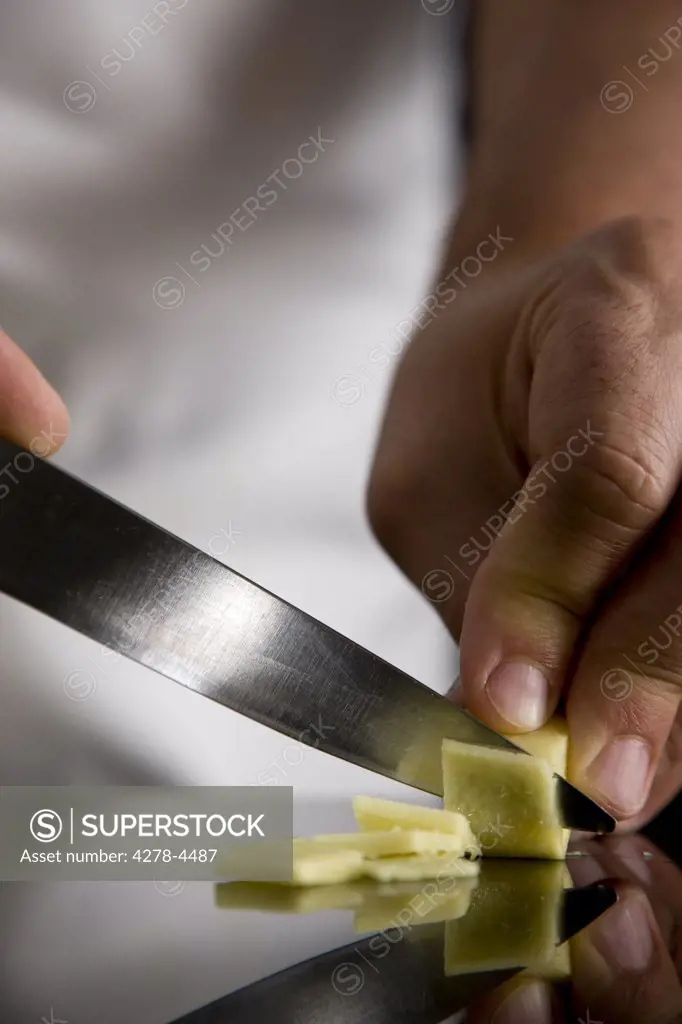 Close up of a chef hand slicing ginger
