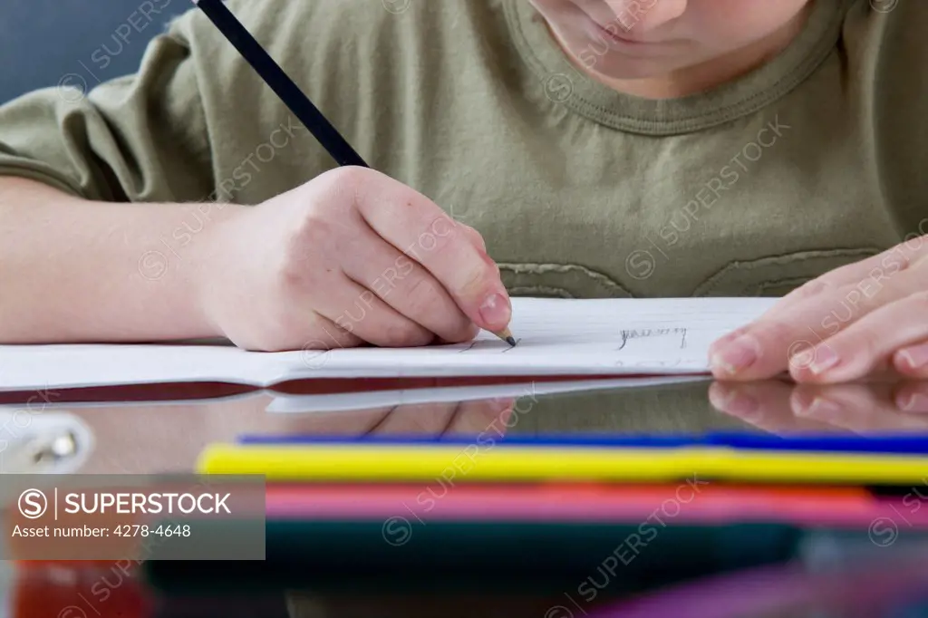 Boy sitting at desk writing