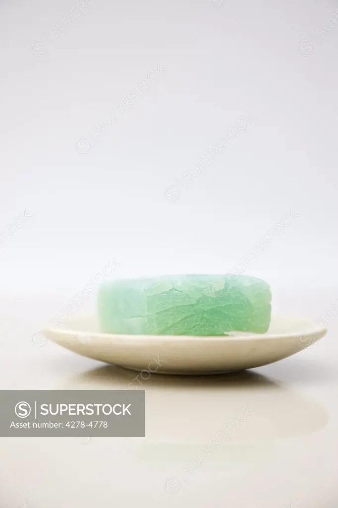 Close up of a green soap on a soap dish