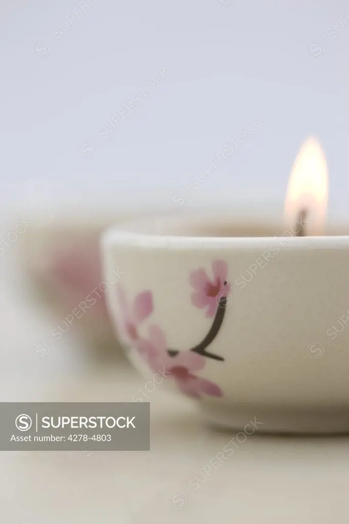 Close up of a burning pink tea light
