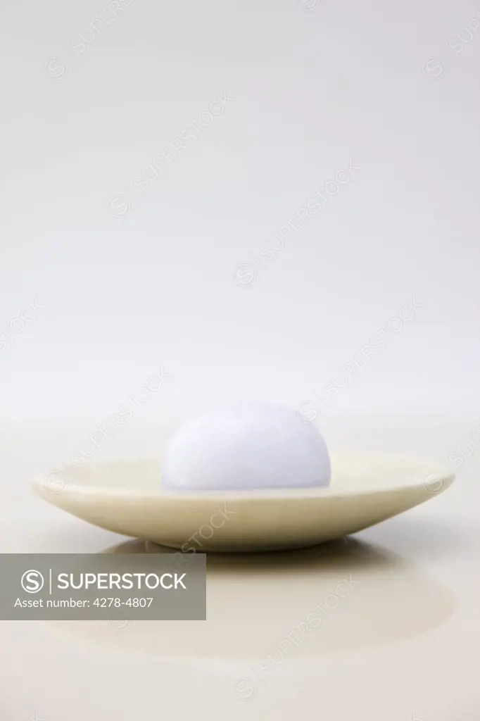 Close up of a lavender soap on a soap dish