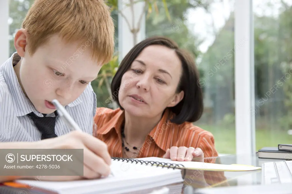 Mother helping son study