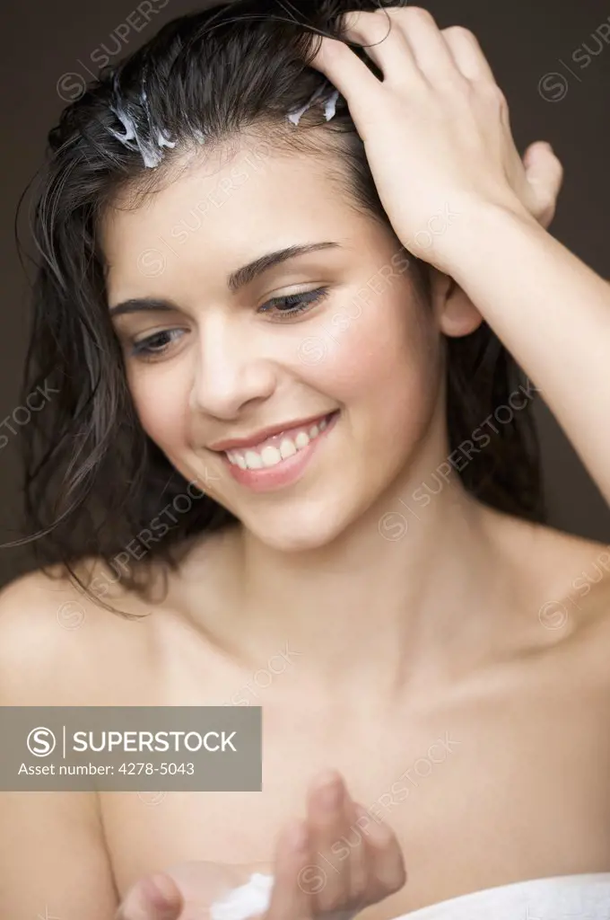 Woman Applying Hair Conditioner