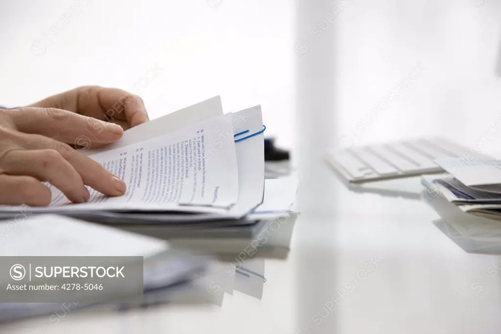 Close up of a woman hands sorting out bills and documents