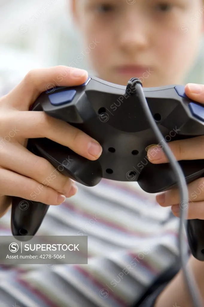 Close up of a boy holding a game controller