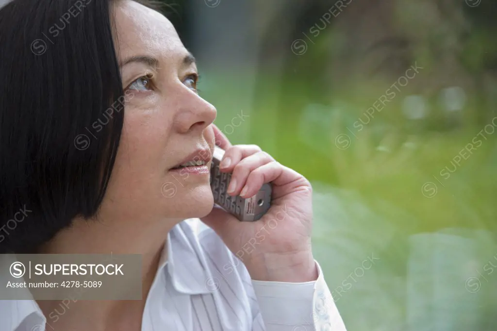 Woman talking on a cordless telephone