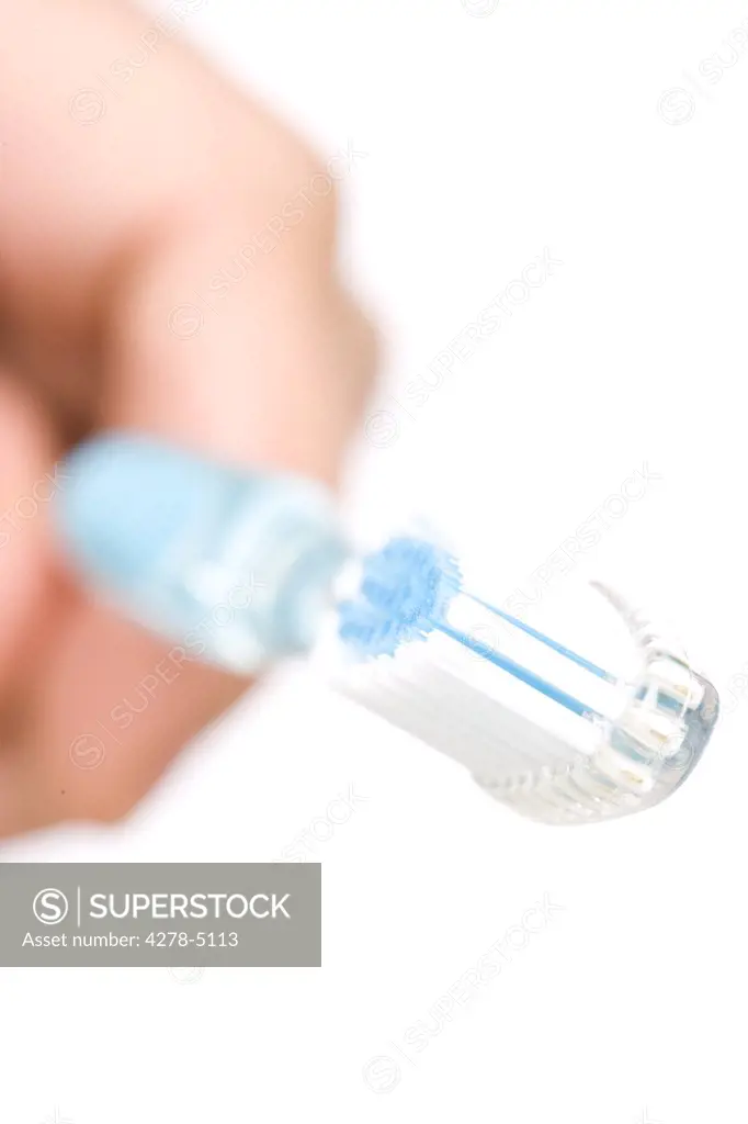 Close up of a man hand holding a toothbrush