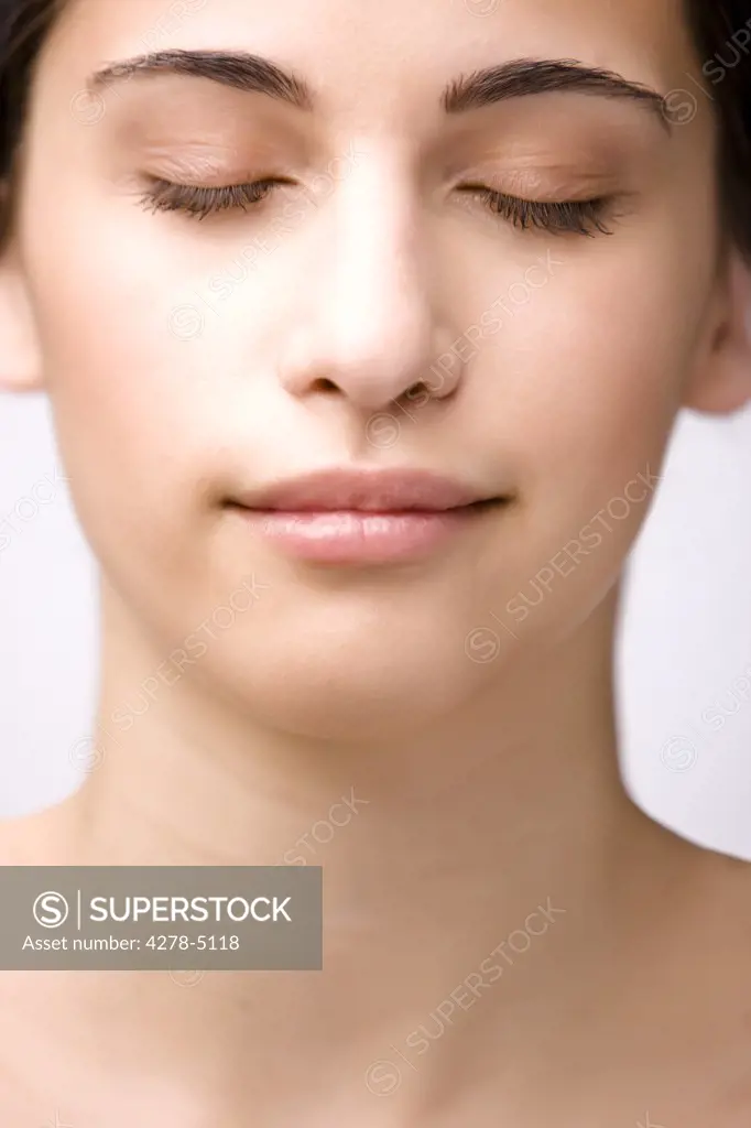 Close up of a young woman with her eyes closed