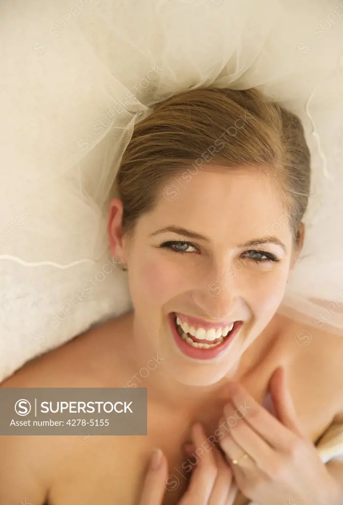 Smiling bride lying on her back