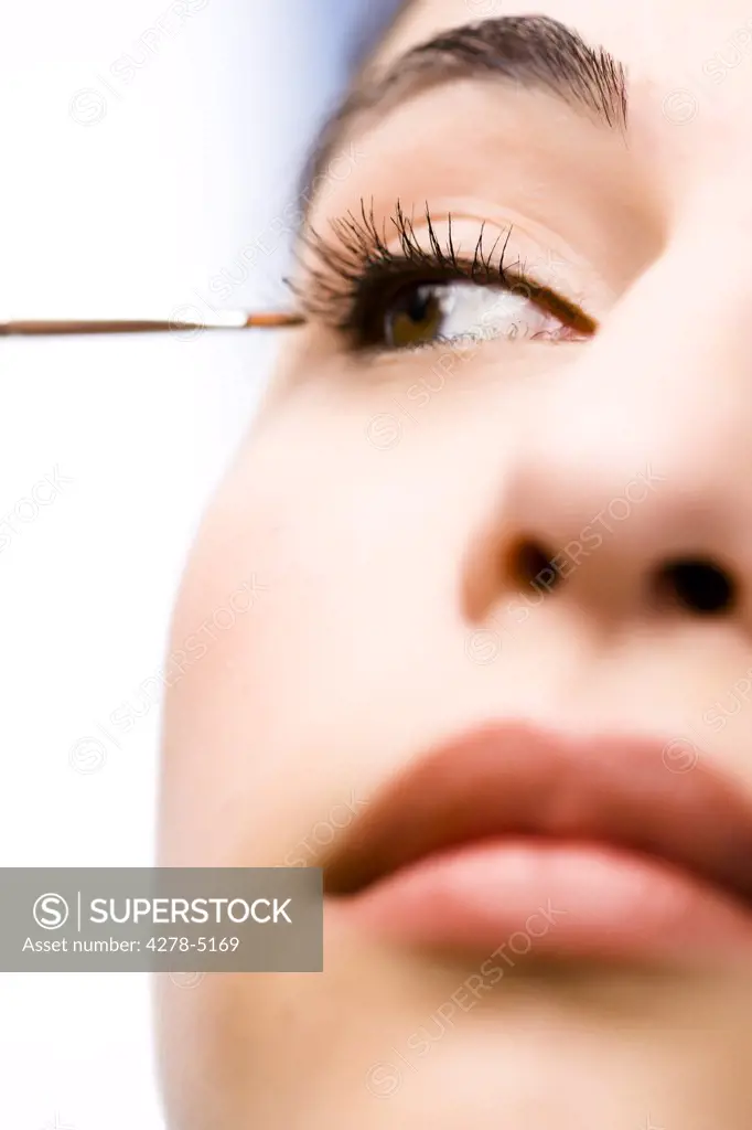 Extreme close up of a woman applying eyeshadow