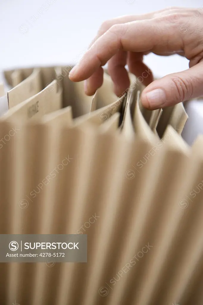 Close up of a woman hand flicking through a file folder