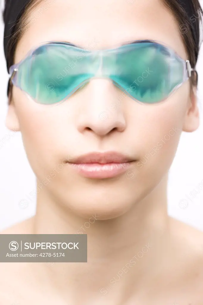 Close up of a young woman wearing a cooling eye mask