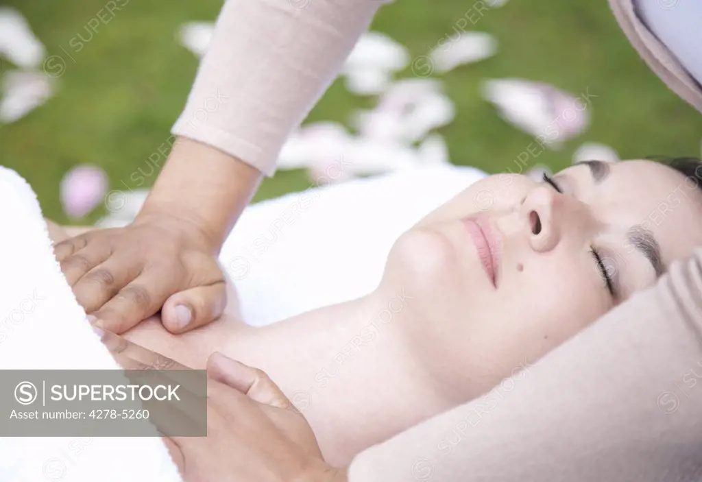 Close up of a woman receiving a chest massage outdoor