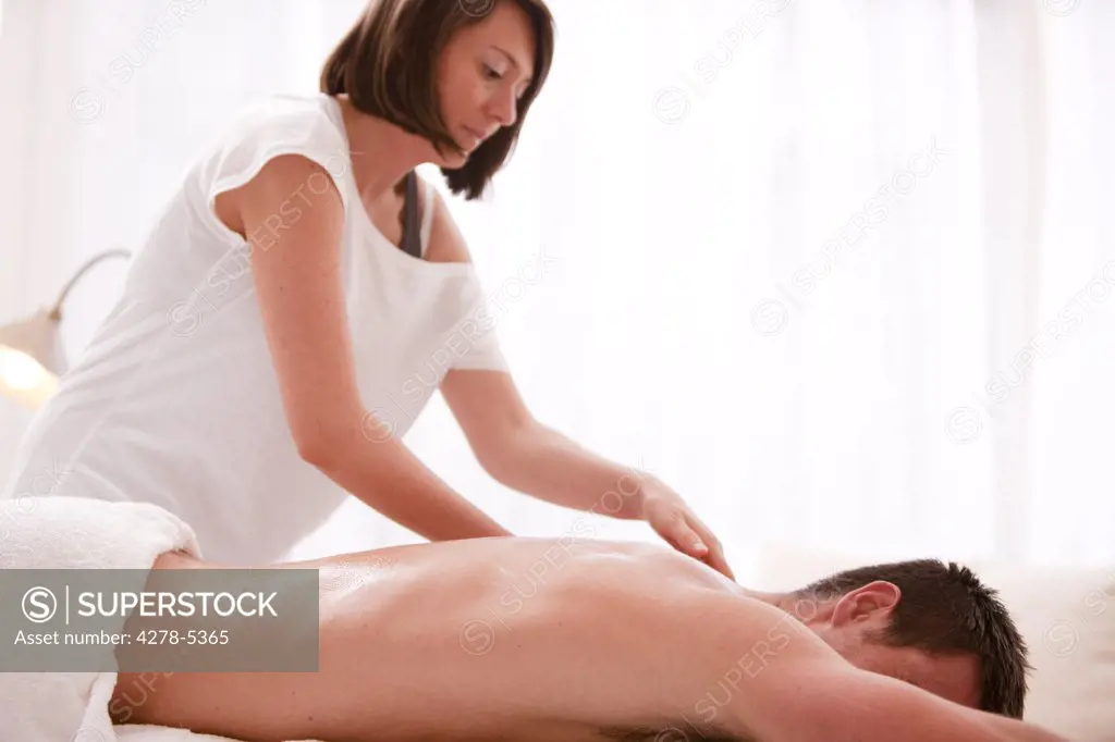 Masseuse giving a man a massage