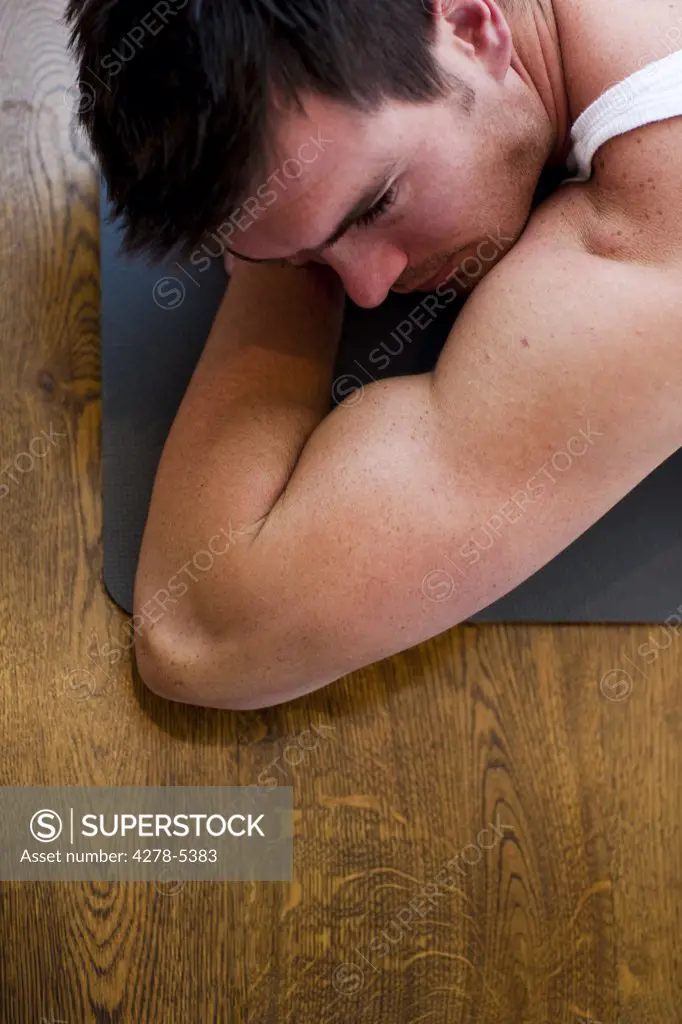 Man lying on a yoga mat
