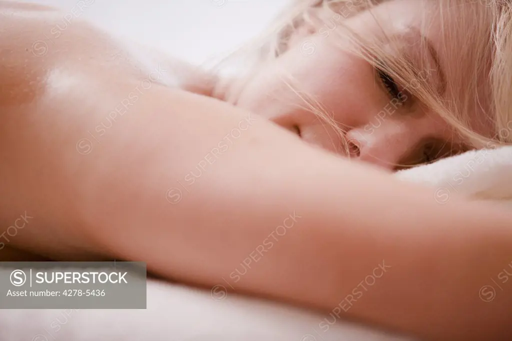 Close up of a woman resting on a massage table