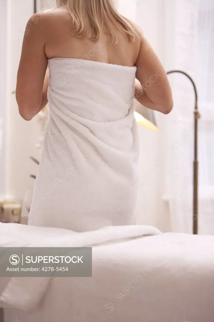 Back view of a woman wrapped in a towel