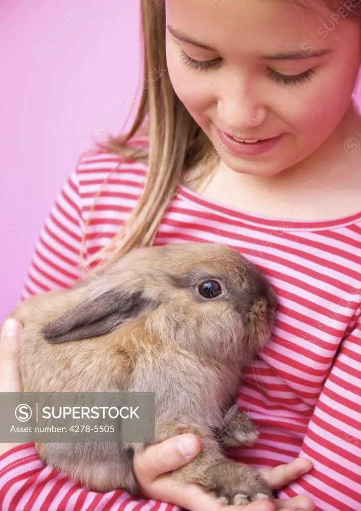 Young girl holding a rabbit