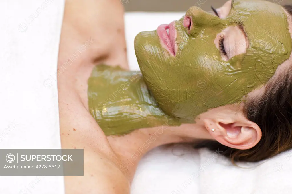 Profile of a woman with green facial mask