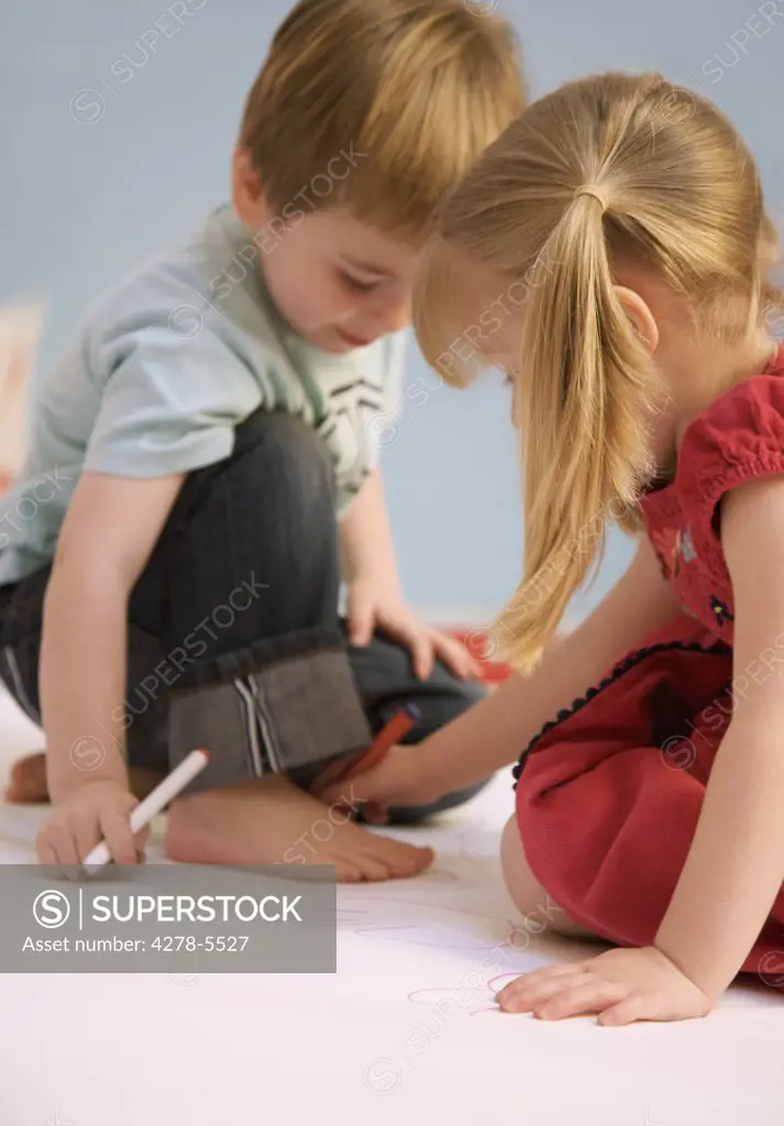 Girl drawing the outline of a boy foot