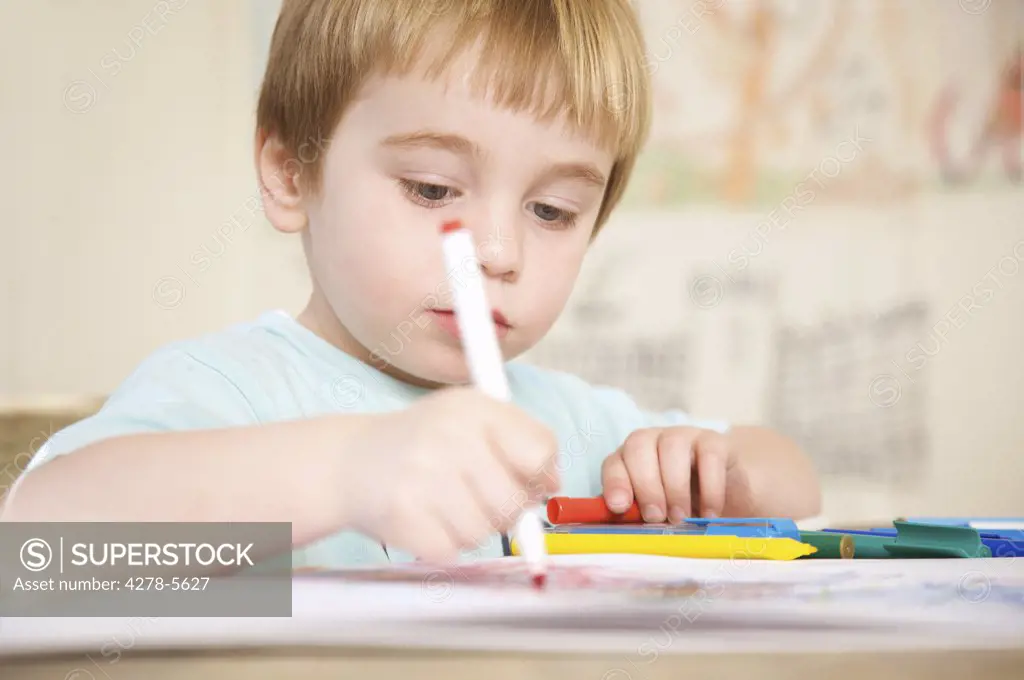 Boy drawing and coloring