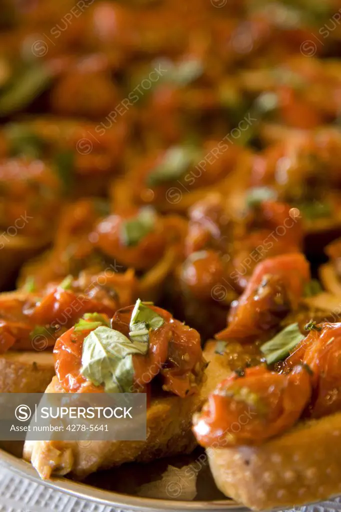 Close up of roasted tomatoes and basil crostini