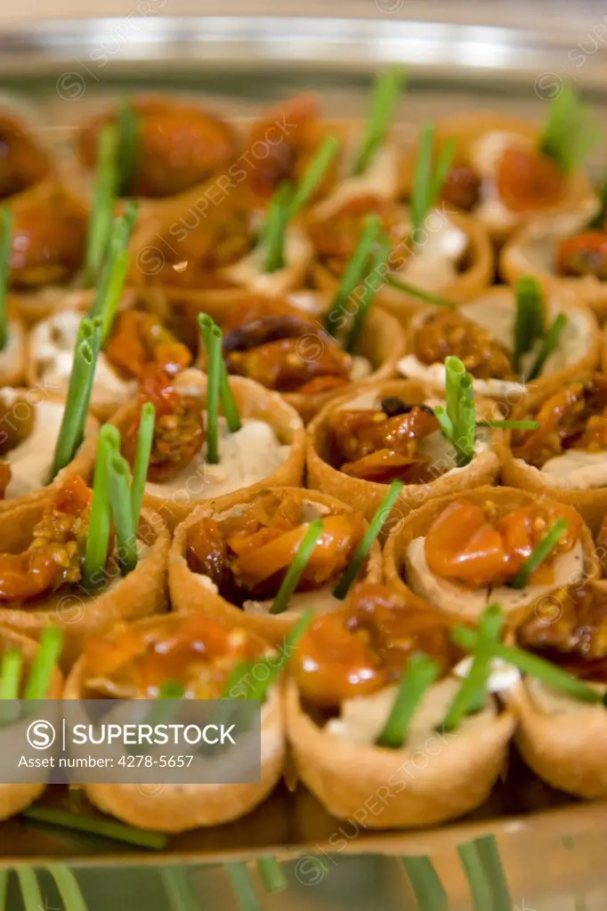 Close up of sun dried tomatoes and chives canapés