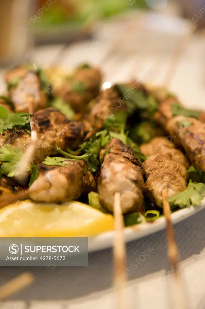 Close up of chicken satay skewers
