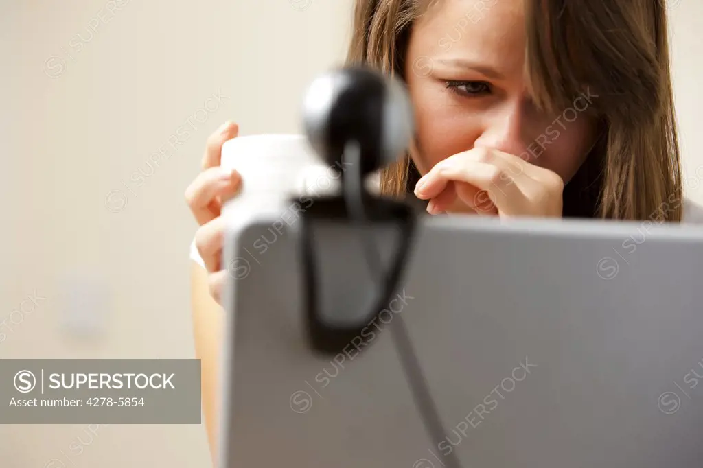 Close up of a woman using laptop computer with web cam