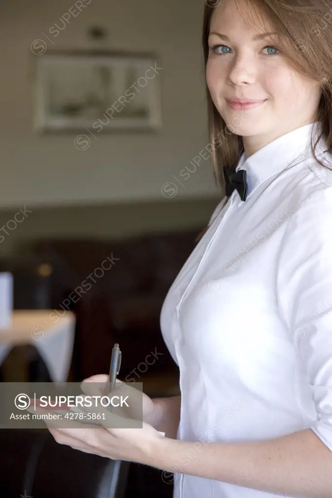 Smiling waitress taking a food order