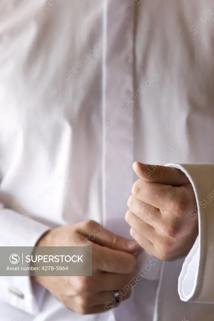 Close up of a waiter's hands with napkin resting on his forearm