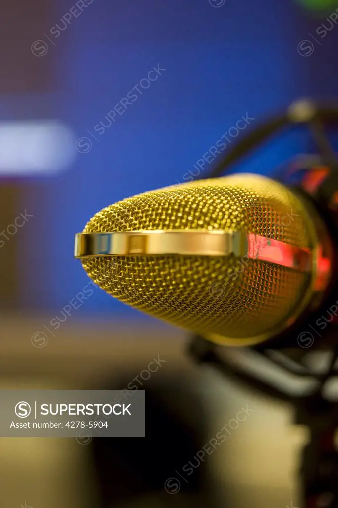 Extreme close up of a gold microphone
