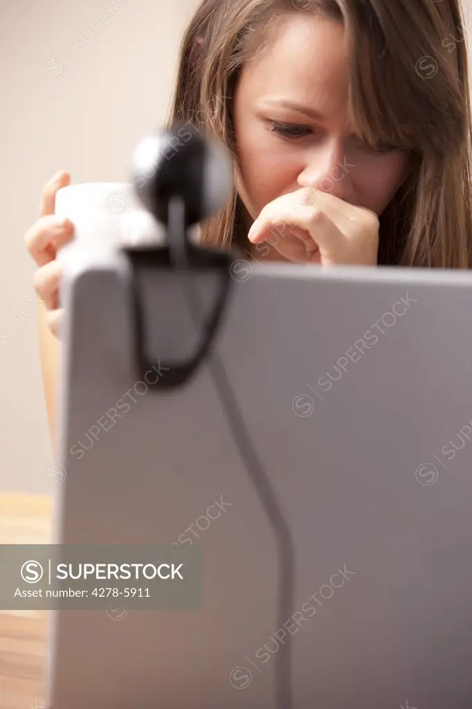 Close up of a woman using laptop computer with web cam